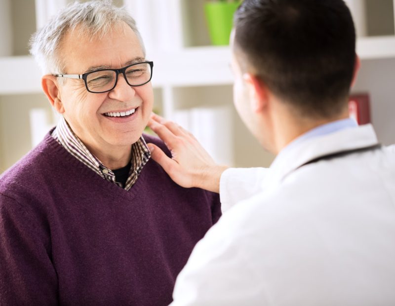 Smiling happy old patient visit doctor